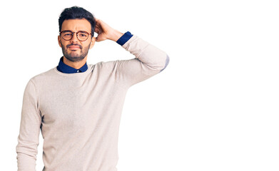 Young handsome hispanic man wearing elegant clothes and glasses confuse and wonder about question....