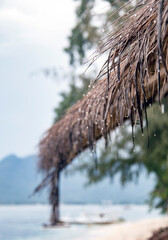 Roofs of beach bars made of palm leaves on a rainy day on Gili Island, Indonesia