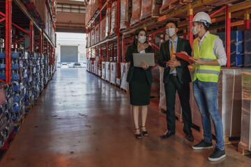 business people with face mask have business talk in factory warehouse