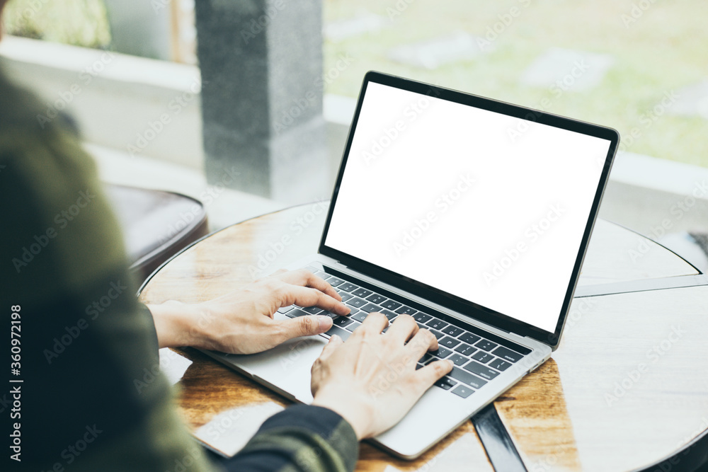 Wall mural computer mockup image blank screen.hand woman work using laptop with white background for advertisin