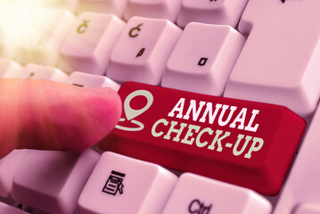 Word writing text Annual Checkup. Business photo showcasing yearly reproductive health visit with a health care provider White pc keyboard with empty note paper above white key copy space