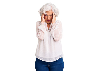 Senior grey-haired woman wearing casual clothes with hand on head for pain in head because stress. suffering migraine.