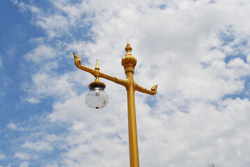 Fototapeta na wymiar Lamp mounted on a high light pole, visible blue sky