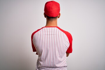 Young handsome african american sportsman wearing striped baseball t-shirt and cap standing backwards looking away with crossed arms