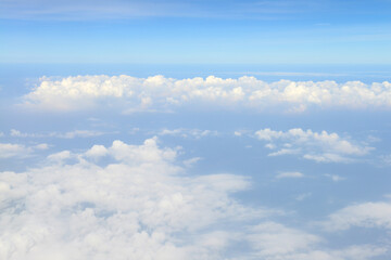 Beautiful view of blue sky above the white clouds from airplane window
