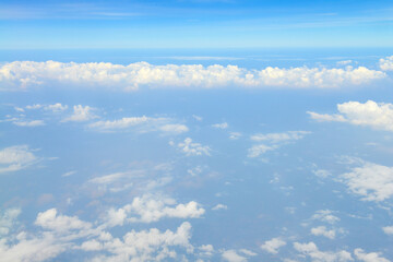 Beautiful view of blue sky above the white clouds from airplane window