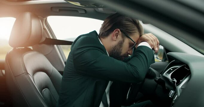 Tired bearded man in formal clothing leaning on car helm during pit-stop on road. Mature businessman in eyeglasses taking break during riding.