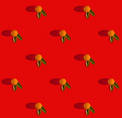 Oranges fruits and leaves on red background creative square pattern, flat lay