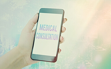 Conceptual hand writing showing Medical Consultation. Concept meaning act of seeking assistance from another physician Modern gadgets white screen under colorful bokeh background