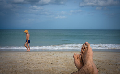 Sandy feet on the beach.