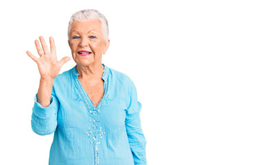 Senior beautiful woman with blue eyes and grey hair wearing summer dress showing and pointing up with fingers number five while smiling confident and happy.