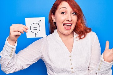 Young redhead woman asking for sex discrimination holding paper with gender equality message...