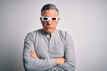 Middle age handsome grey-haired man using 3d glasses over isolated white background skeptic and nervous, disapproving expression on face with crossed arms. Negative person.