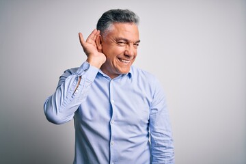 Middle age handsome grey-haired business man wearing elegant shirt over white background smiling...