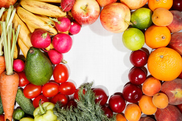 Healthy food, photo of fruits and vegetables on a white wooden table. Top view, copy space in the center.