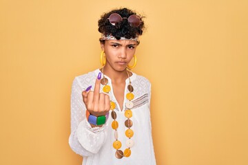 Young beautiful african american afro hippie woman wearing sunglasses and accessories Showing...