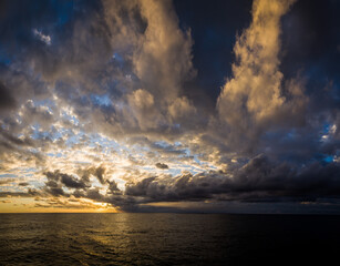 Naklejka na ściany i meble sunset over the Atlantic ocean clouds
