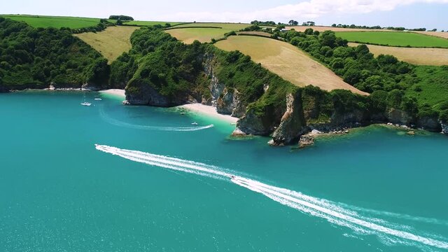 Aerial of summer time leisure boats cruising along St Austell bay in Cornwall