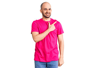 Fototapeta premium Young handsome man wearing casual t shirt cheerful with a smile of face pointing with hand and finger up to the side with happy and natural expression on face