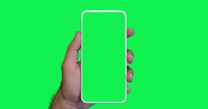 man's hand holding a smartphone with a vertical green screen in tram chroma key smartphone technology cell phone touch message display hand with luma white and black key