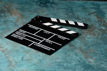 Clapper board with popcorn. Movie concept. Clapperboard on a textural background. Close-up. Copy...