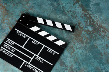 Clapper board with popcorn. Movie concept. Clapperboard on a textural background. Close-up. Copy...
