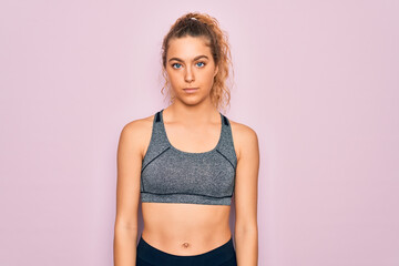 Fototapeta na wymiar Young beautiful blonde sportswoman with blue eyes doing exercise wearing sportswear Relaxed with serious expression on face. Simple and natural looking at the camera.
