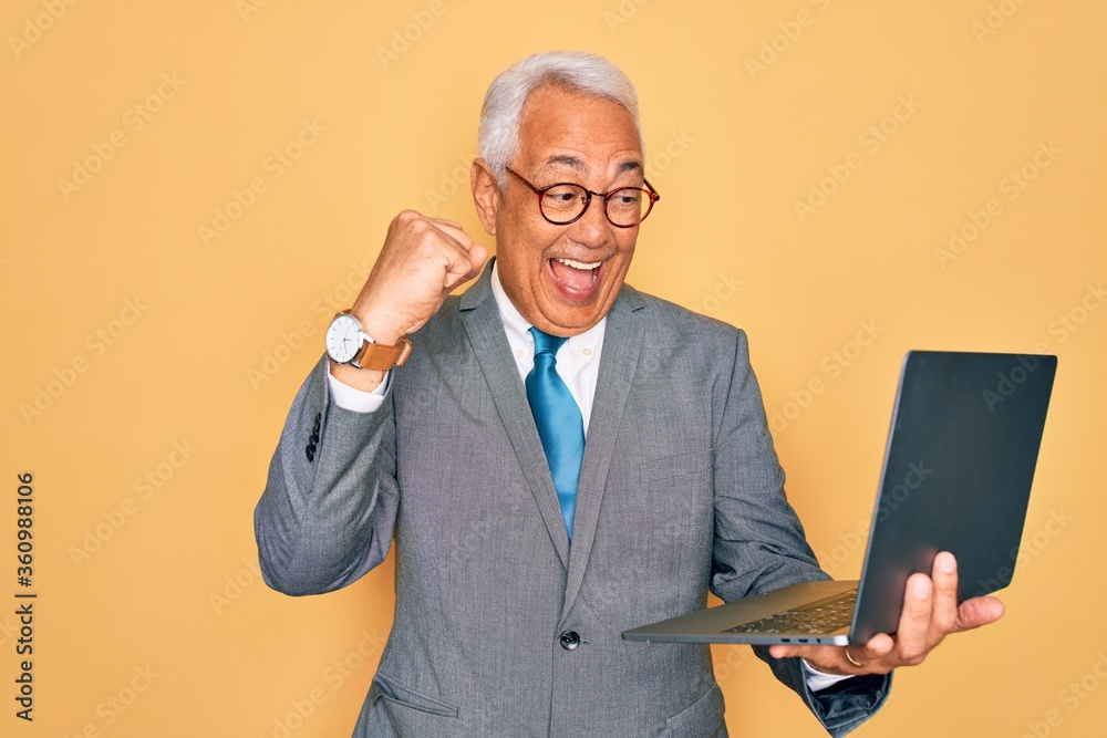 Wall mural middle age senior grey-haired business man wearing glasses working using computer laptop screaming p