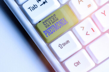 Text sign showing Severe Pneumonia. Business photo showcasing acute disease that is marked by inflammation of lung tissue White pc keyboard with empty note paper above white key copy space