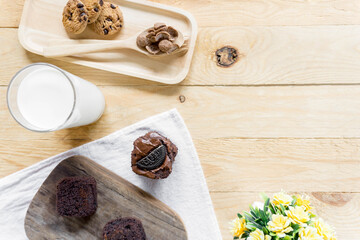 Flay lay brownie on wooden plate and ingredient. Top view food with copy space