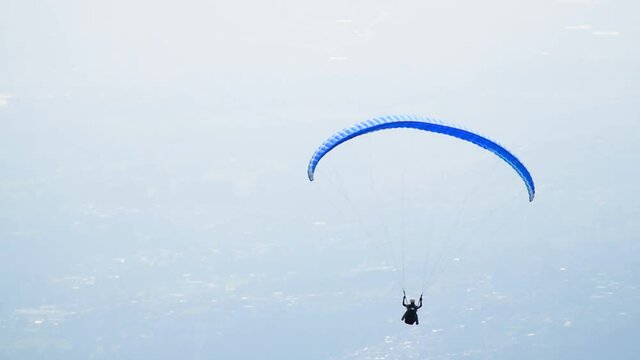 Skydiver paraglider. Beautiful tranquil and calm time in nature over town and highway daylight. Adrenaline, extreme sport.