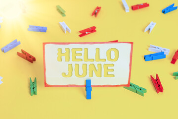 Conceptual hand writing showing Hello June. Concept meaning a new month to plan your activities for fun and adventures Colored clothespin papers empty reminder yellow floor office