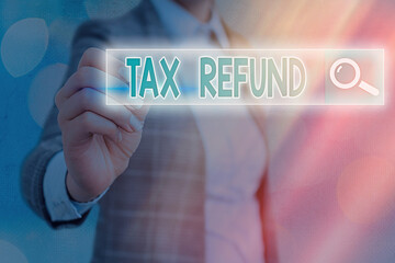 Writing note showing Tax Refund. Business concept for excess payment of paid taxes returned to...