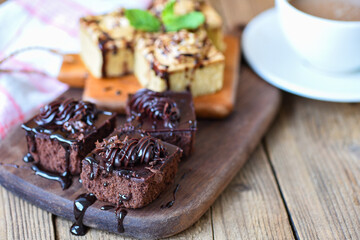 Coffee cake delicious dessert served on the table - cake chocolate slice on wooden board background with mint leaf and coffee cup for breakfast