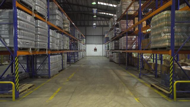 Dolly in of Rows of shelves with boxes Interior Of Modern warehouse.