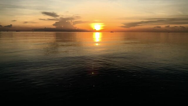 Beautiful sunset over the sea. Orange and gold blue sky.