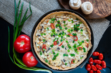 Homemade hot quiche with ingredients, tomatoes and mushrooms still life, flat lay, cooking home