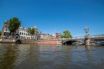 Fototapeta na wymiar Bridge over the river channel in the center of Amsterdam