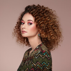 Fototapeta premium Beautiful woman in a jacket. Perfect makeup. Beauty fashion. Cosmetic. Eyeshadow. Elegant afro curly hairstyle