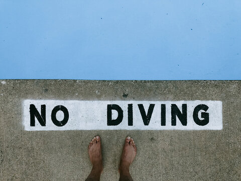 No diving stenciled pooldeck singage.