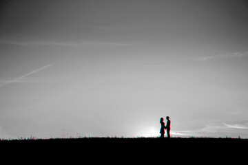 Naklejka na ściany i meble silhouette of a couple in love hugging together