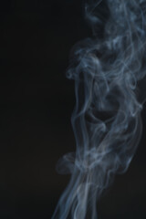Blurred images of white smoke, black background conceptualization.