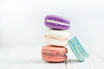 Close up view of four French macaroons on a white background. Sweet and colorful French macaroons....