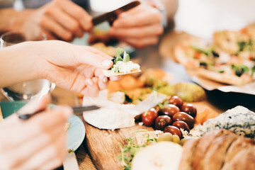 Table full of tasty and delicious food close-up. Pizza, cheeze, olives and snacks