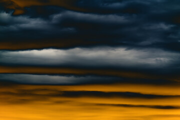 Dramatic sunset sky with dark thunderstorms clouds