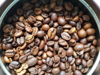 Coffee beans lie in a jar