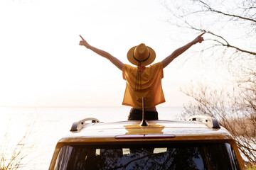 Woman Spread Arms Widely at Car Sunroof Back View. Young Girl with Outstretched Hands Weekend...