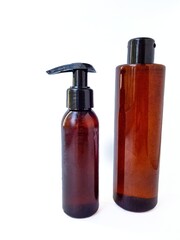 Cosmetic bottle containers in black on a white background with a blank label for the brand layout on a white background. Space for text.