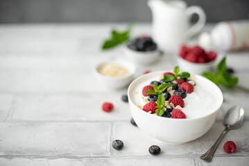 fresh greek yogurt with blueberries, raspberries and mint