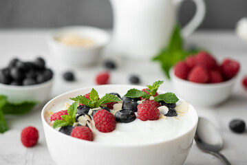 fresh greek yogurt with blueberries, raspberries and mint